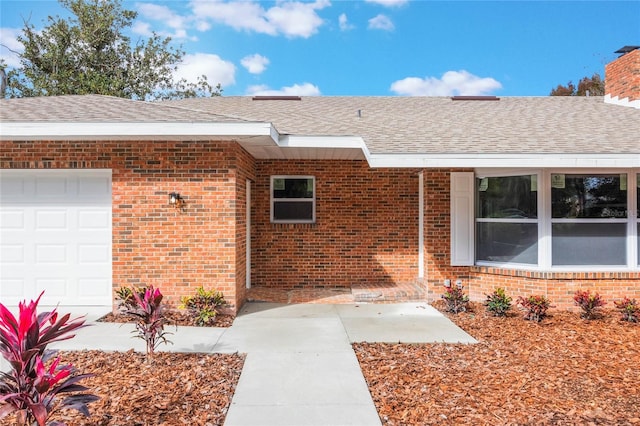 doorway to property with a garage