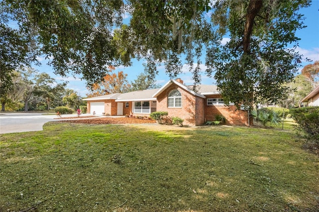 ranch-style house with a garage and a front lawn