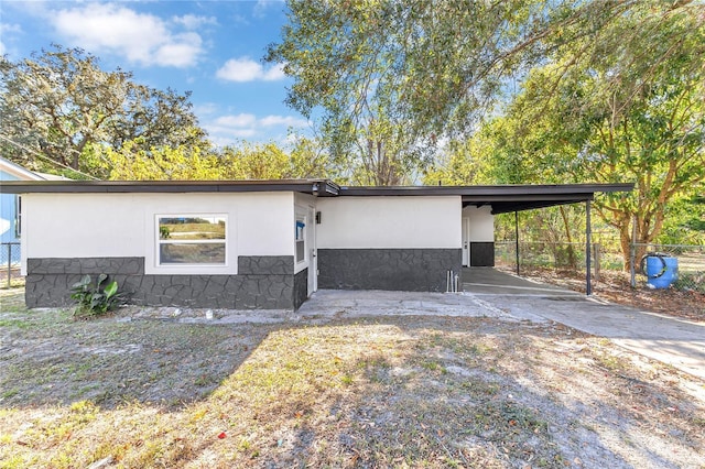 view of side of home with a carport