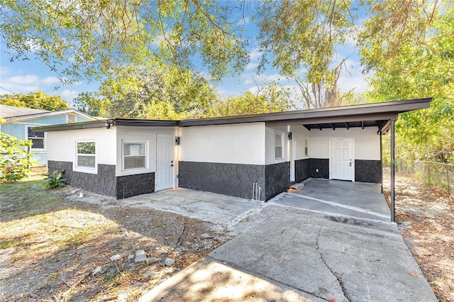 ranch-style house featuring a carport