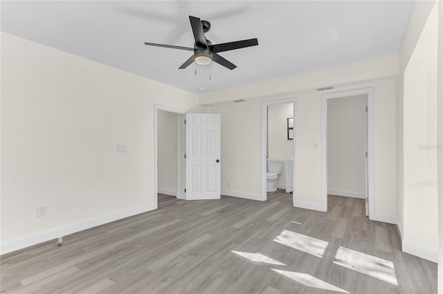 unfurnished bedroom featuring ensuite bathroom, a closet, ceiling fan, and light wood-type flooring