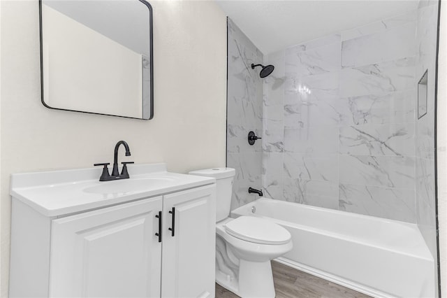 full bathroom featuring vanity, hardwood / wood-style flooring, toilet, and tiled shower / bath