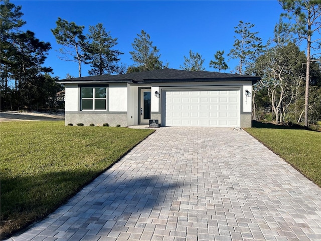 single story home with a garage and a front lawn