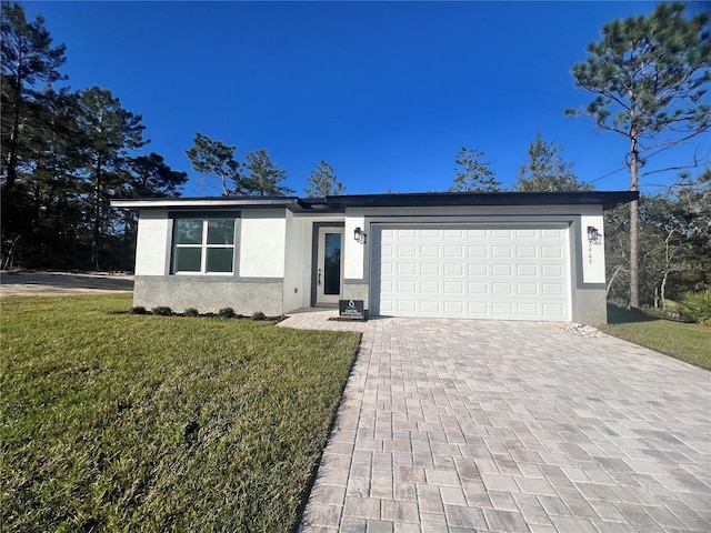 single story home with a front yard and a garage