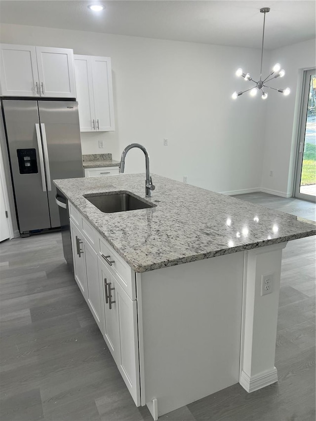 kitchen featuring sink, white cabinets, a center island with sink, and appliances with stainless steel finishes