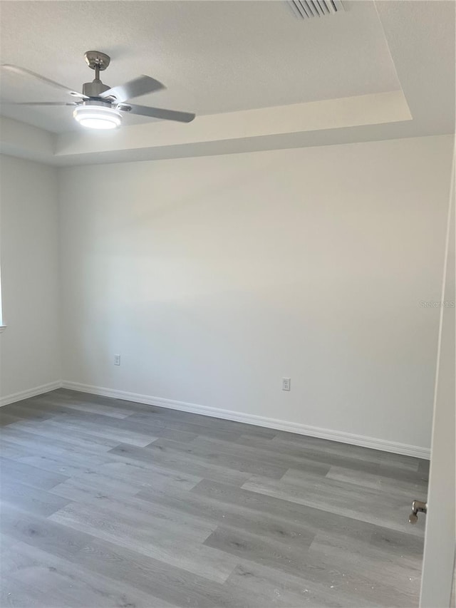 spare room featuring hardwood / wood-style flooring and ceiling fan