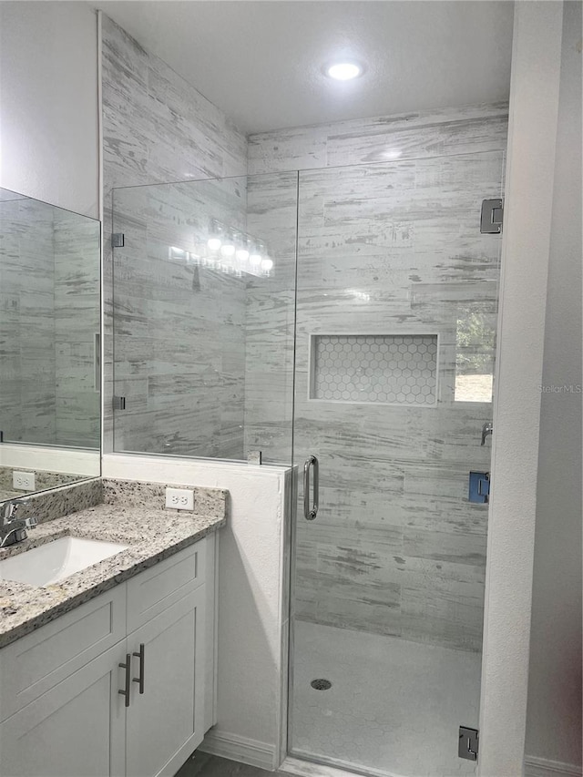 bathroom with vanity and an enclosed shower