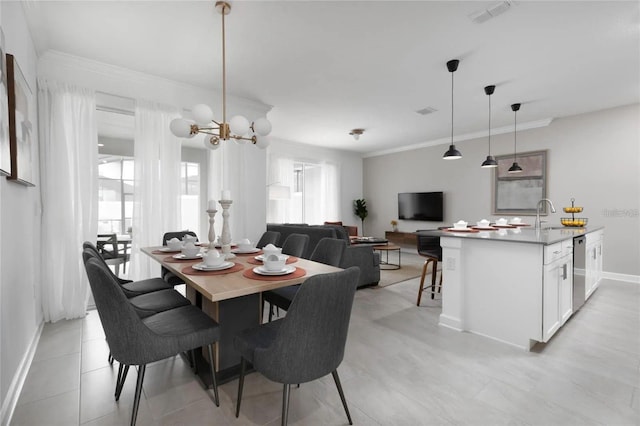 dining space with crown molding, sink, and a notable chandelier