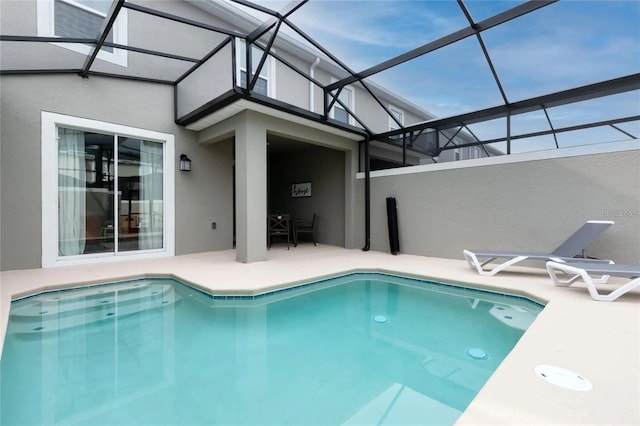 view of swimming pool with a lanai and a patio