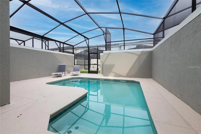 view of swimming pool featuring a lanai and a patio