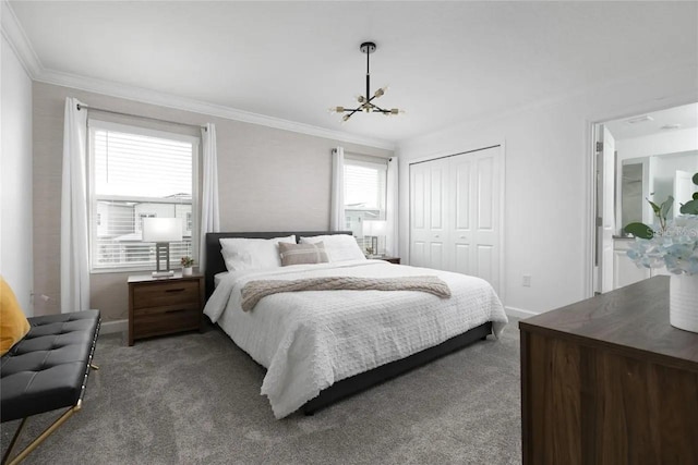 bedroom featuring dark colored carpet, an inviting chandelier, a closet, and ornamental molding