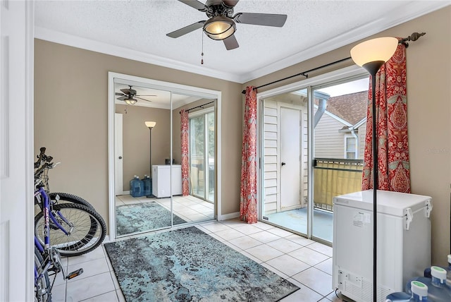 doorway with a textured ceiling, light tile patterned floors, and crown molding