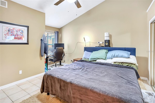 tiled bedroom with ceiling fan and vaulted ceiling