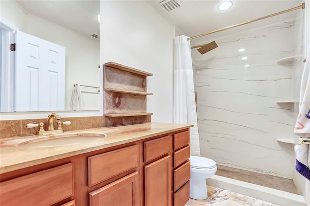 bathroom with vanity, curtained shower, and toilet