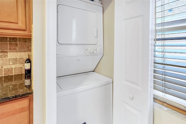 laundry room featuring stacked washer and dryer