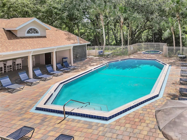 view of swimming pool with a community hot tub and a patio