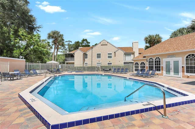 view of pool with french doors and a patio