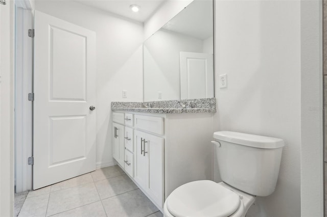 bathroom featuring tile patterned flooring, vanity, and toilet