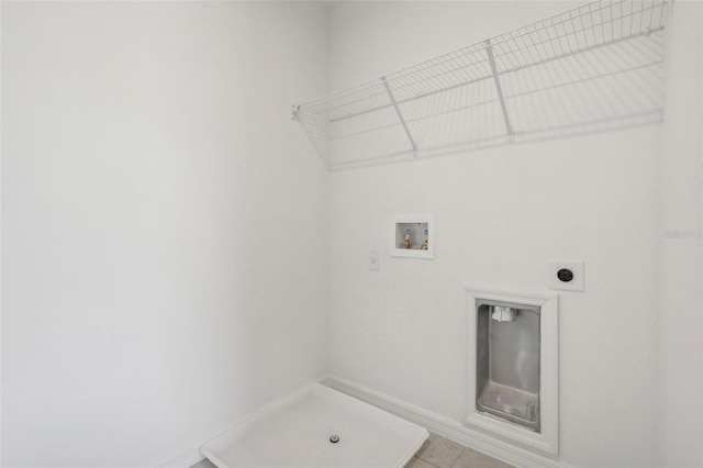 clothes washing area featuring hookup for a washing machine, electric dryer hookup, and light tile patterned flooring