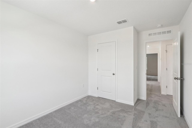 unfurnished bedroom featuring light colored carpet