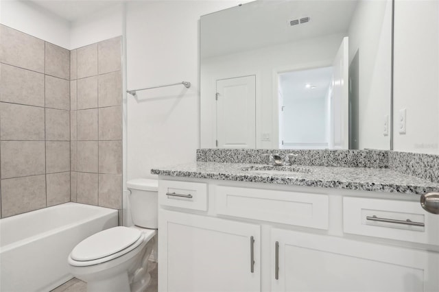 full bathroom featuring vanity, toilet, and tiled shower / bath combo