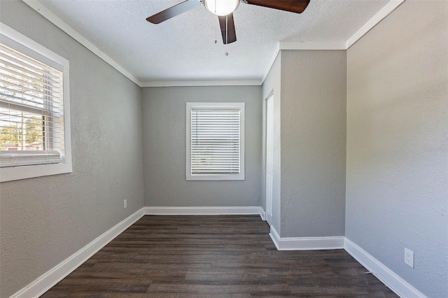 spare room with a textured ceiling, crown molding, ceiling fan, and dark wood-type flooring