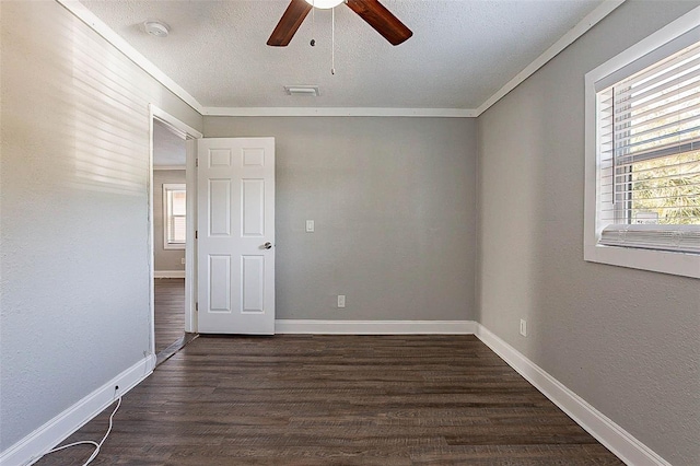 spare room featuring ceiling fan, ornamental molding, and dark wood-type flooring