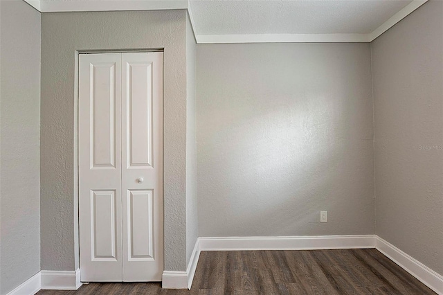 spare room with dark wood-type flooring