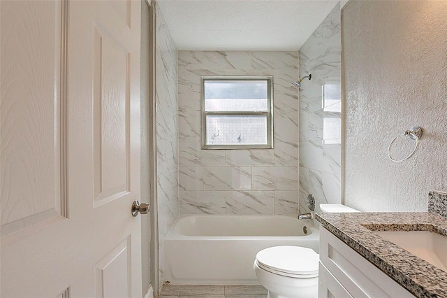 full bathroom with a textured ceiling, vanity, tiled shower / bath combo, and toilet