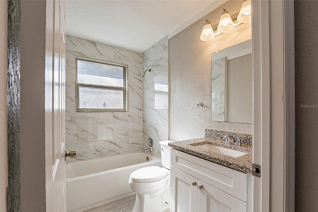 full bathroom with vanity, a textured ceiling, toilet, and tiled shower / bath