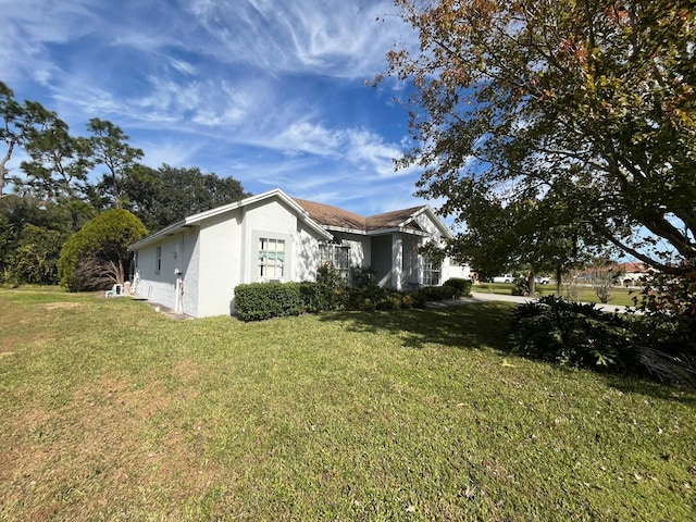 view of side of home featuring a lawn