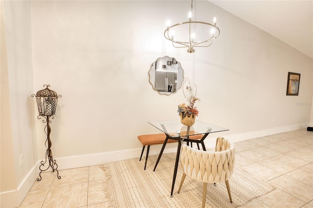 dining space with a notable chandelier, light tile patterned floors, and vaulted ceiling