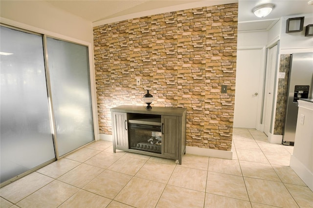 room details with a fireplace and stainless steel fridge with ice dispenser