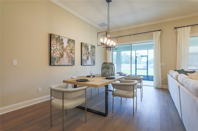 dining room featuring an inviting chandelier, dark hardwood / wood-style floors, and ornamental molding