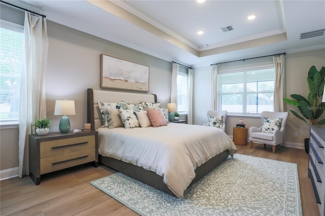 bedroom featuring wood-type flooring, multiple windows, and ornamental molding