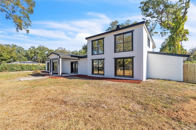 rear view of house with a yard