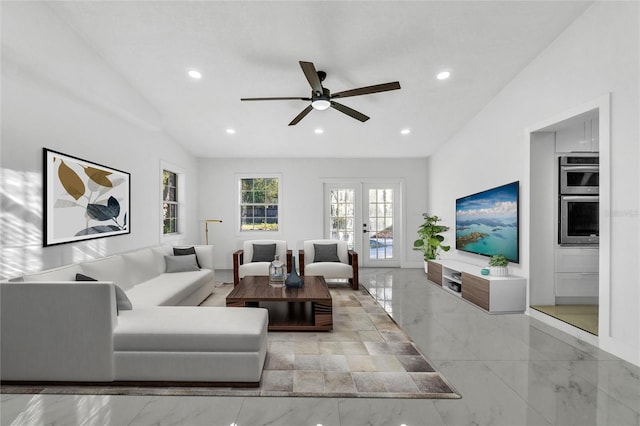 living room with french doors, ceiling fan, and vaulted ceiling