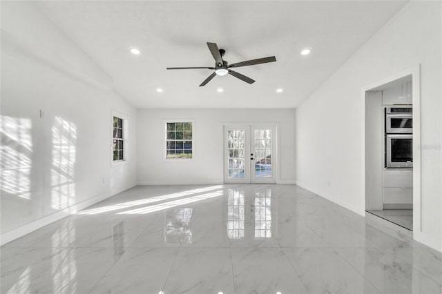 unfurnished living room featuring french doors and ceiling fan