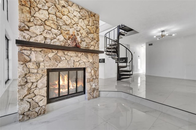 unfurnished living room featuring a stone fireplace