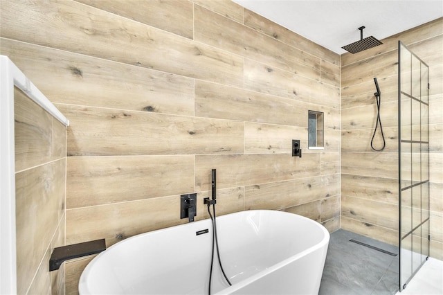 bathroom with wooden walls and independent shower and bath