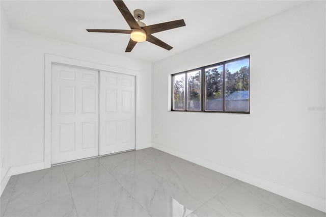 unfurnished bedroom with a closet and ceiling fan