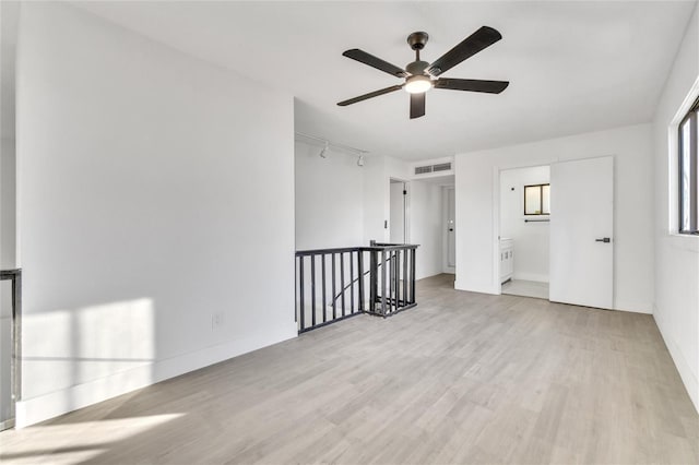 spare room featuring ceiling fan and light hardwood / wood-style floors