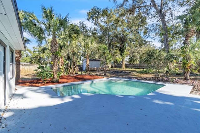 view of swimming pool with a storage unit