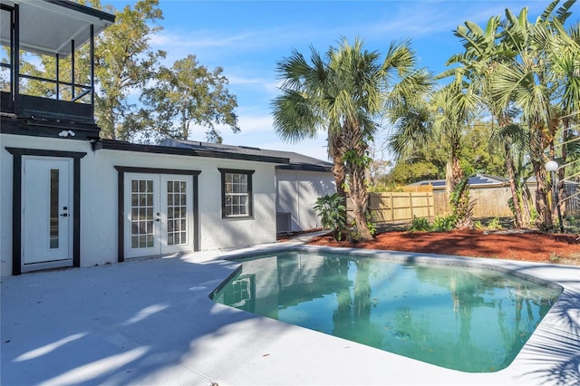 view of swimming pool with a patio and french doors