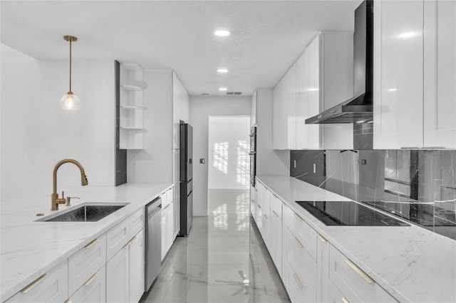 kitchen with pendant lighting, appliances with stainless steel finishes, sink, and white cabinets