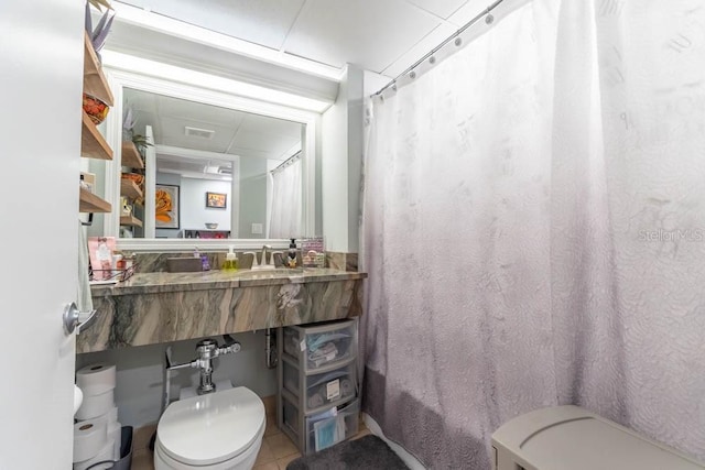 full bathroom featuring sink, tile patterned flooring, shower / tub combo with curtain, and toilet