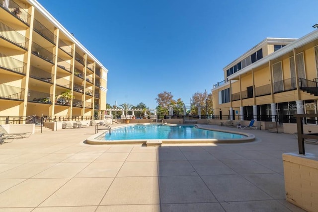 view of swimming pool with a patio