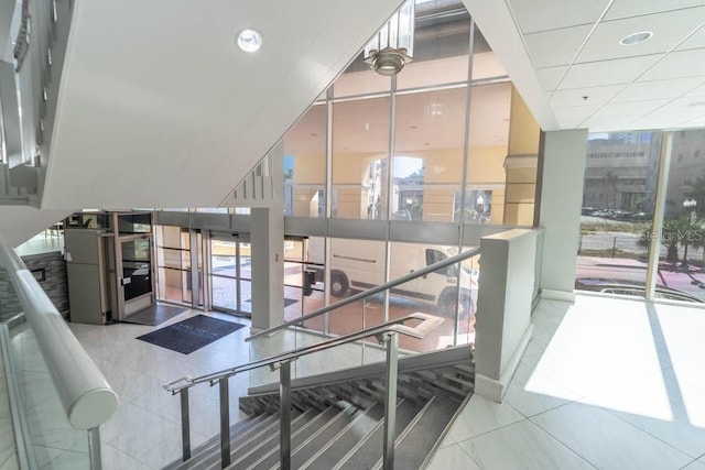 151 E Washington St Unit 201, Orlando, FL 32801 - staircase featuring plenty of natural light, tile patterned flooring, and expansive windows