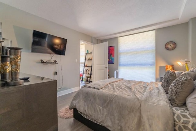 151 E Washington St Unit 201, Orlando, FL 32801 - bedroom with dark wood-type flooring and baseboards