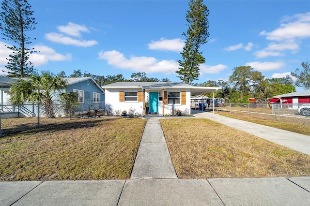 view of front of house with a front lawn and a carport